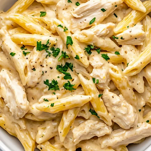 Creamy chicken Alfredo pasta in white bowl