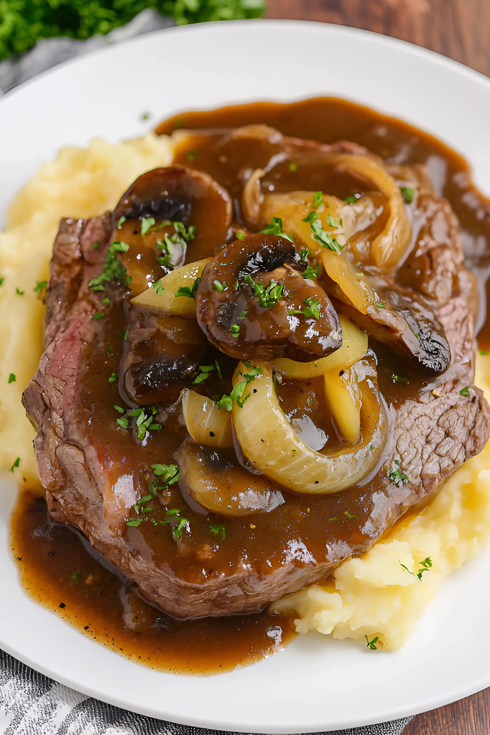Plated Slow Cooker Round Steak and Gravy with mashed potatoes