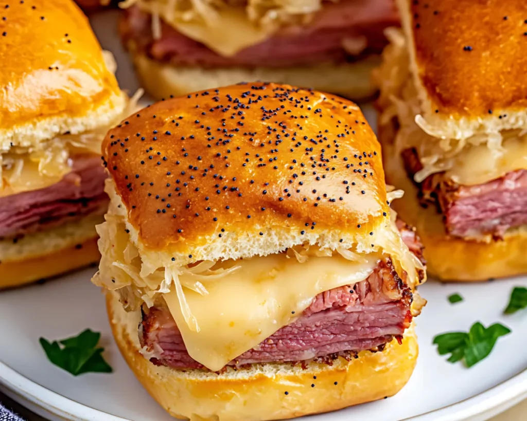 Reuben sliders garnished with parsley on a round white plate