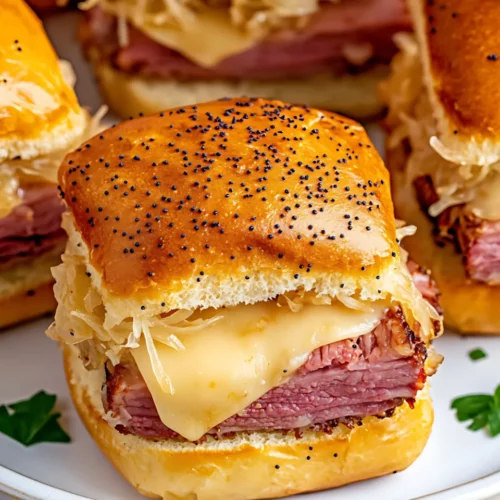 Reuben sliders garnished with parsley on a round white plate