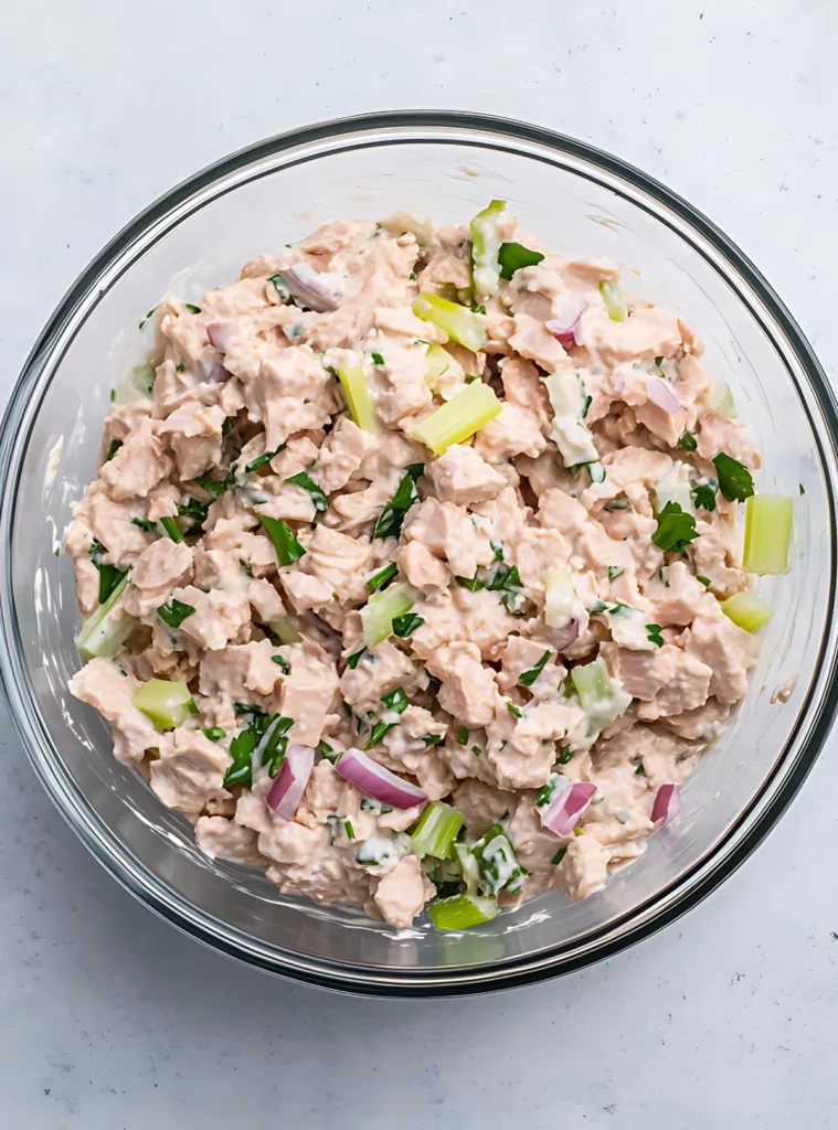Tuna salad mixed in a glass bowl