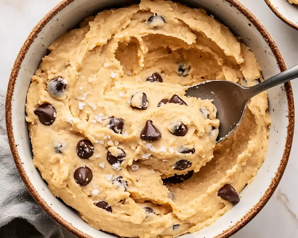 Cookie dough in bowl with scattered chips