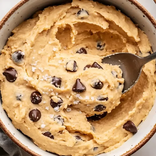 Cookie dough in bowl with scattered chips