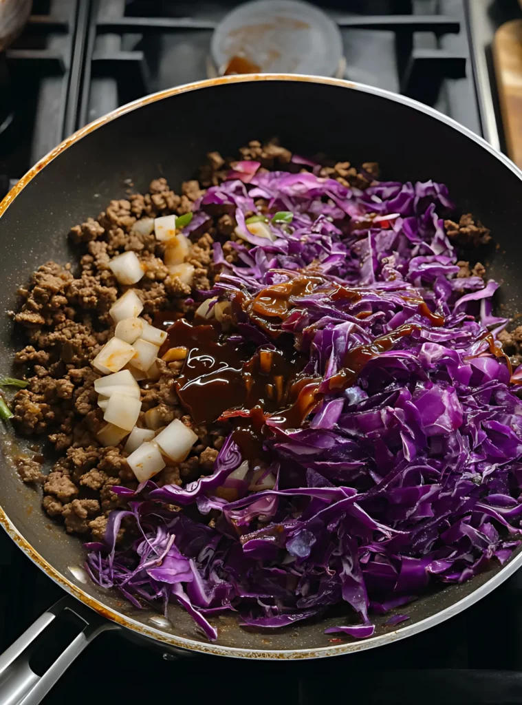 Ground beef cabbage and sauce in pan