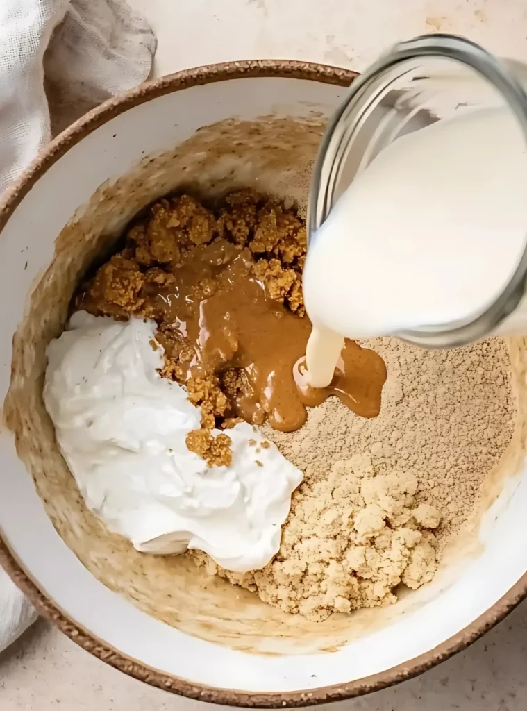 Ingredients in bowl with milk being poured