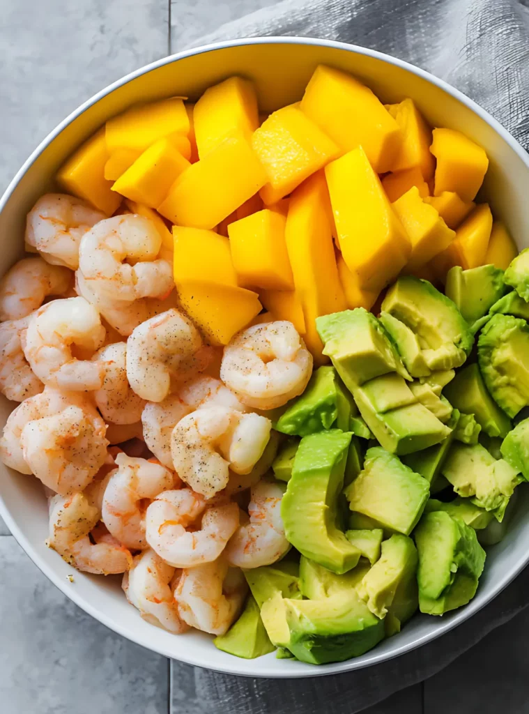 Raw shrimp mango avocado in prep bowl
