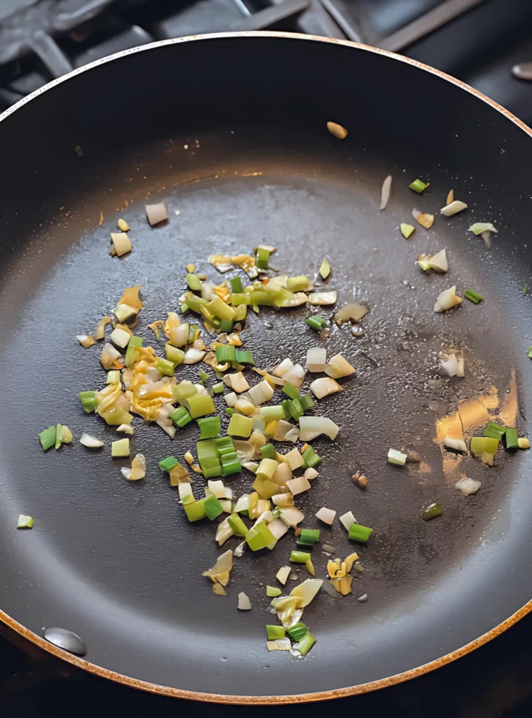 Sautéed garlic and scallions in skillet