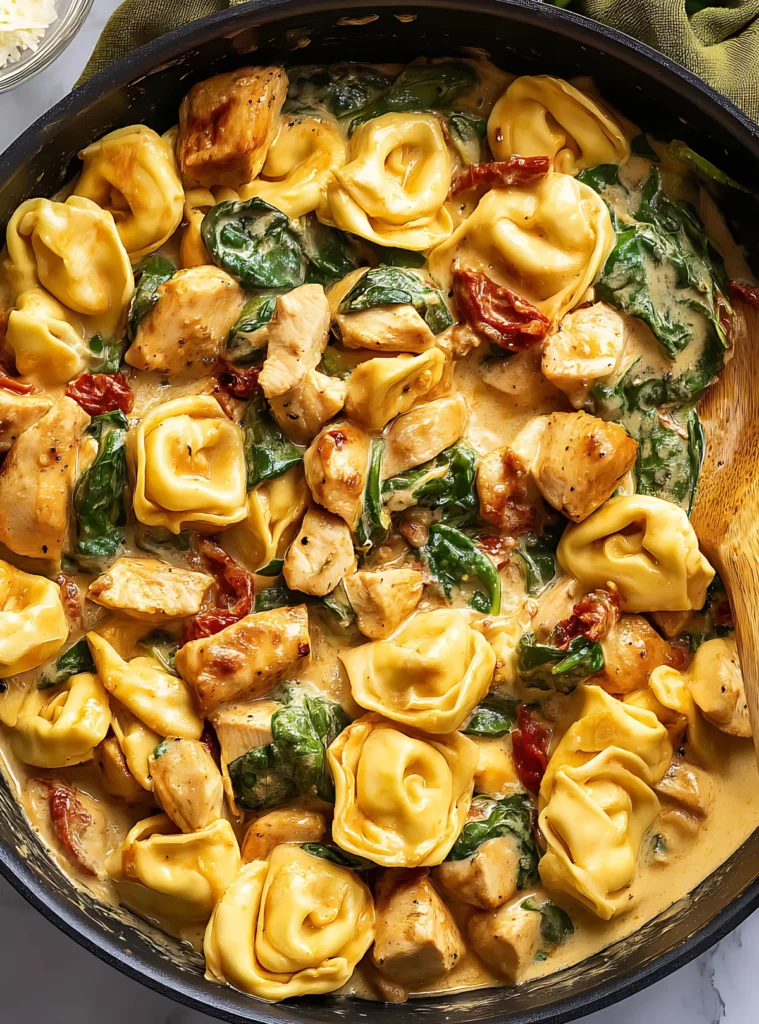 Tortellini chicken pasta in skillet with spoon