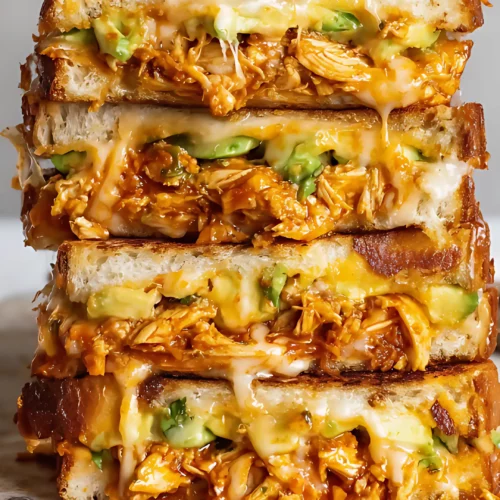 Cheesy chicken avocado melt on marble board