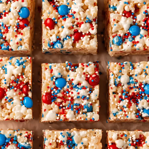 Close up of square rice krispie treats with colorful toppings