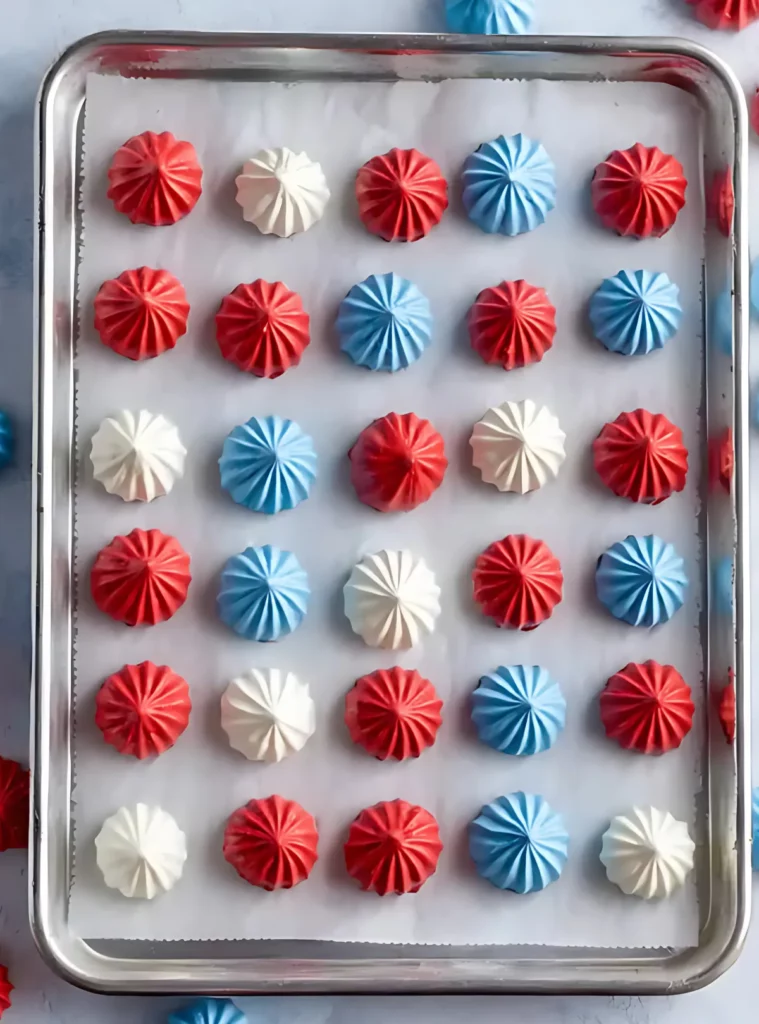 Colorful meringues lined on baking tray