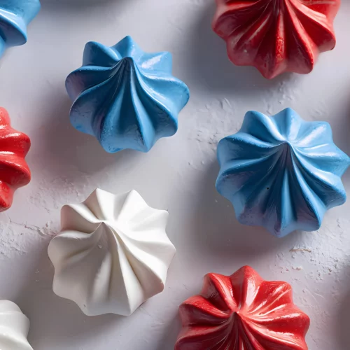Red white blue meringues on white surface
