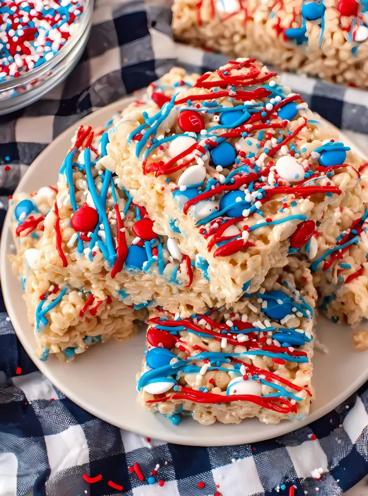 Stack of patriotic rice krispie treats on a white plate
