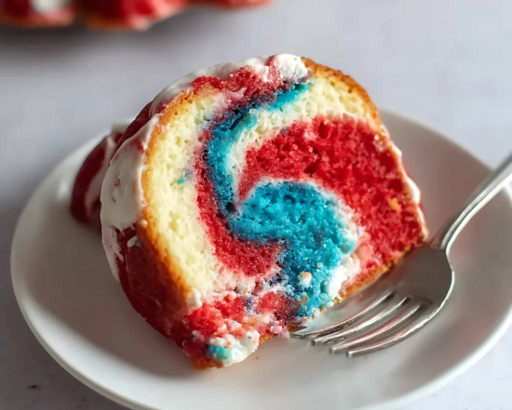 Swirled bundt cake slice with fork on plate
