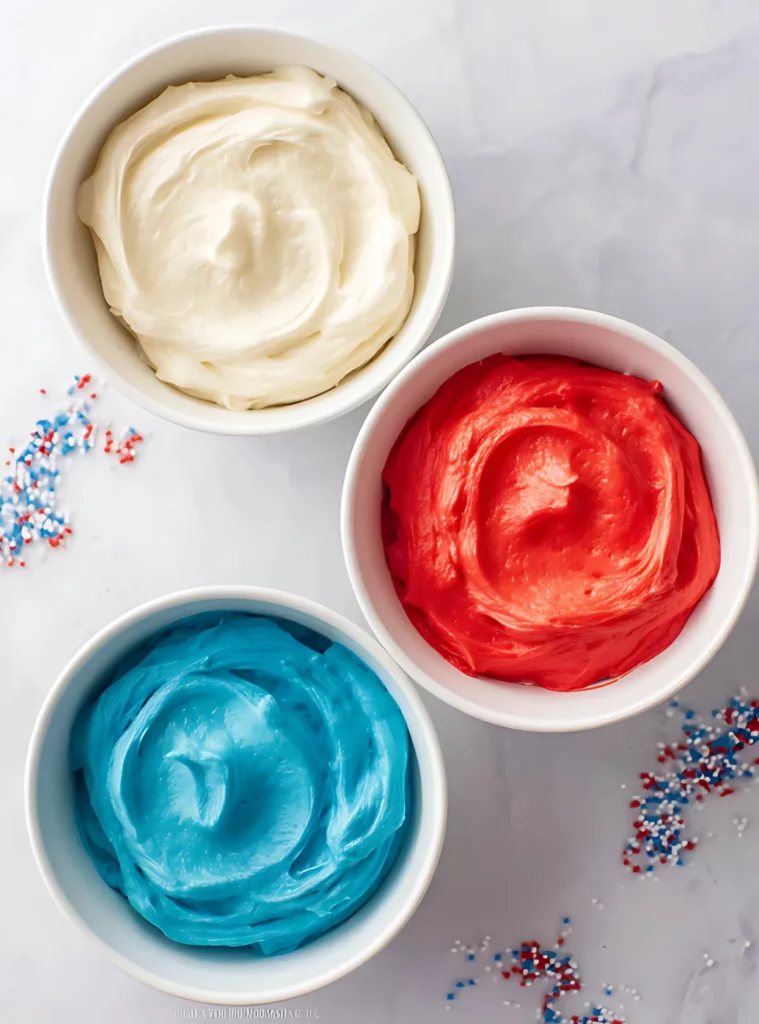 Three bowls of colored frosting