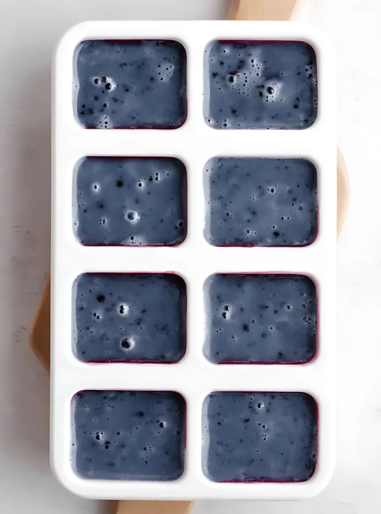 blueberry mixture in white popsicle mold
