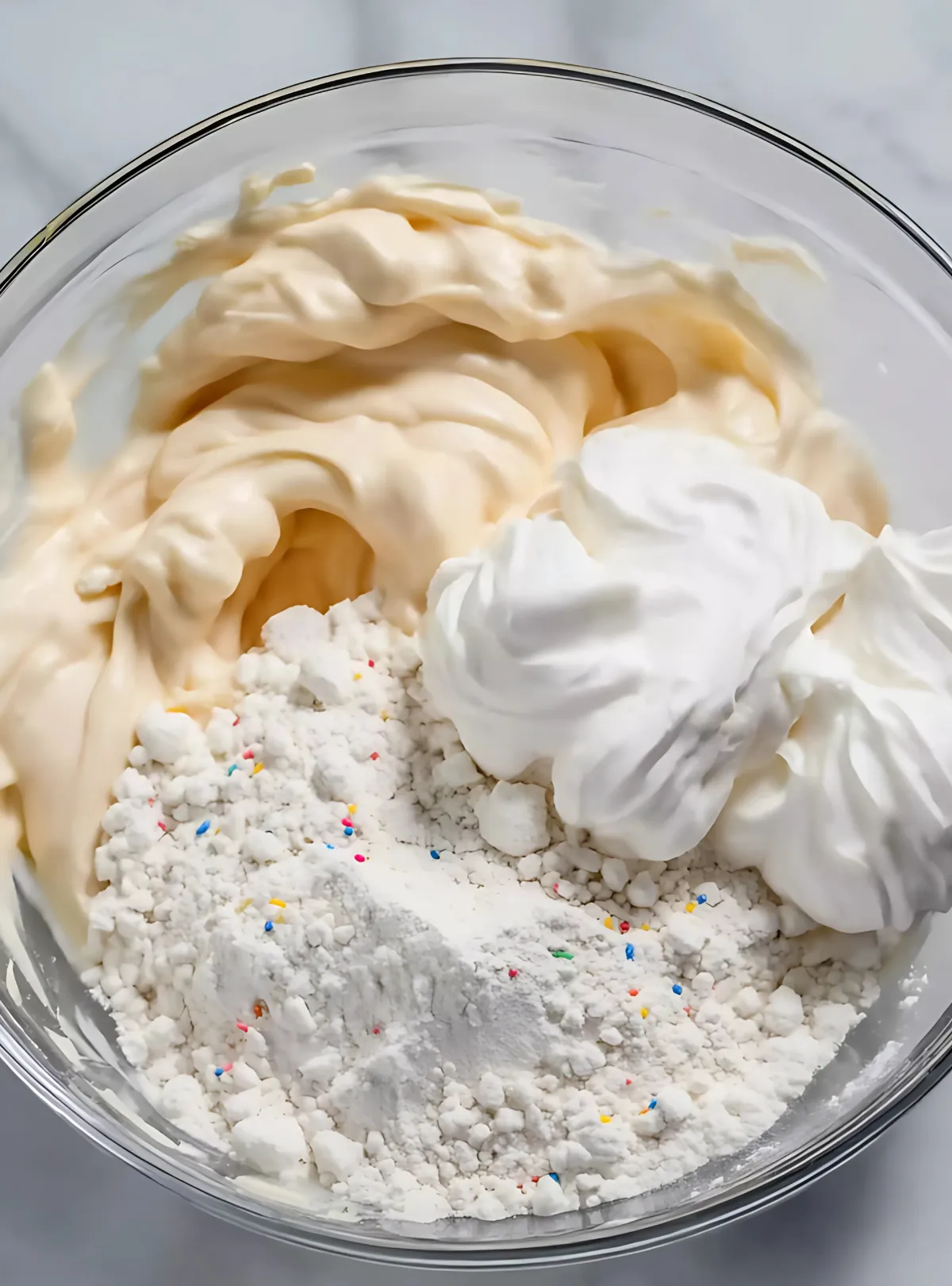 bowl with whipped topping yogurt and cake mix