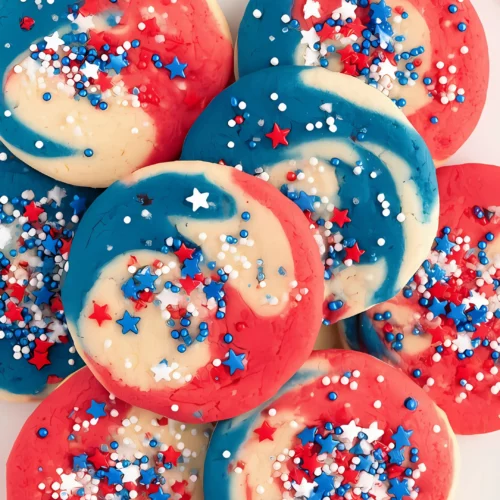 colorful cookies with sprinkles on white plate