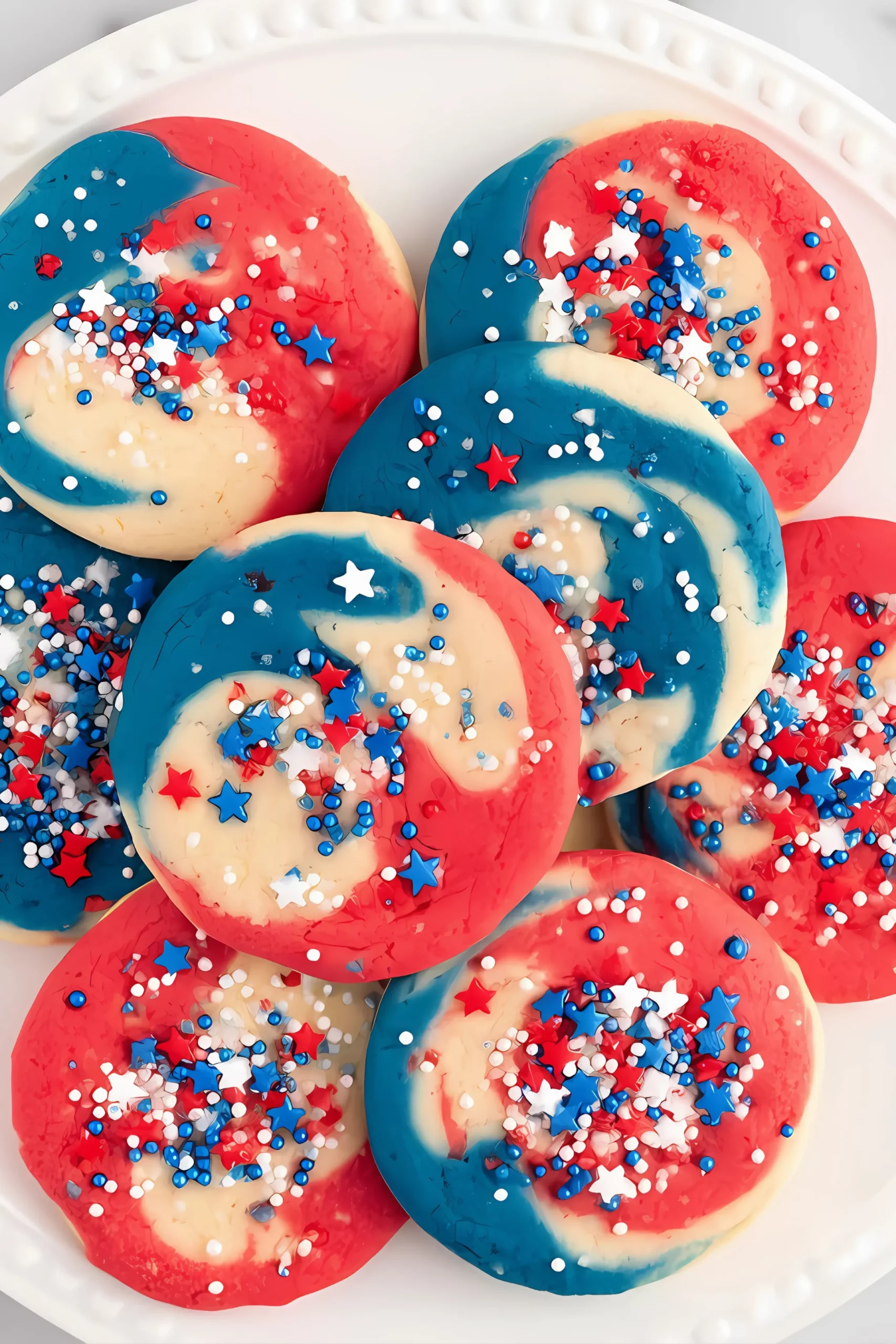 colorful cookies with sprinkles on white plate