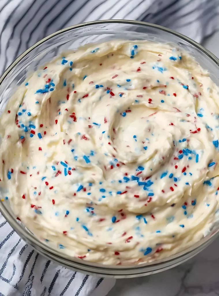 dip with red white and blue sprinkles in a glass bowl