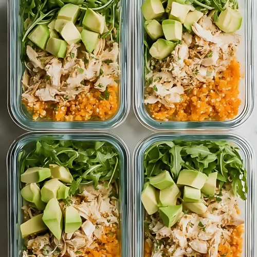 four containers of arugula chicken avocado carrot rice meal prep