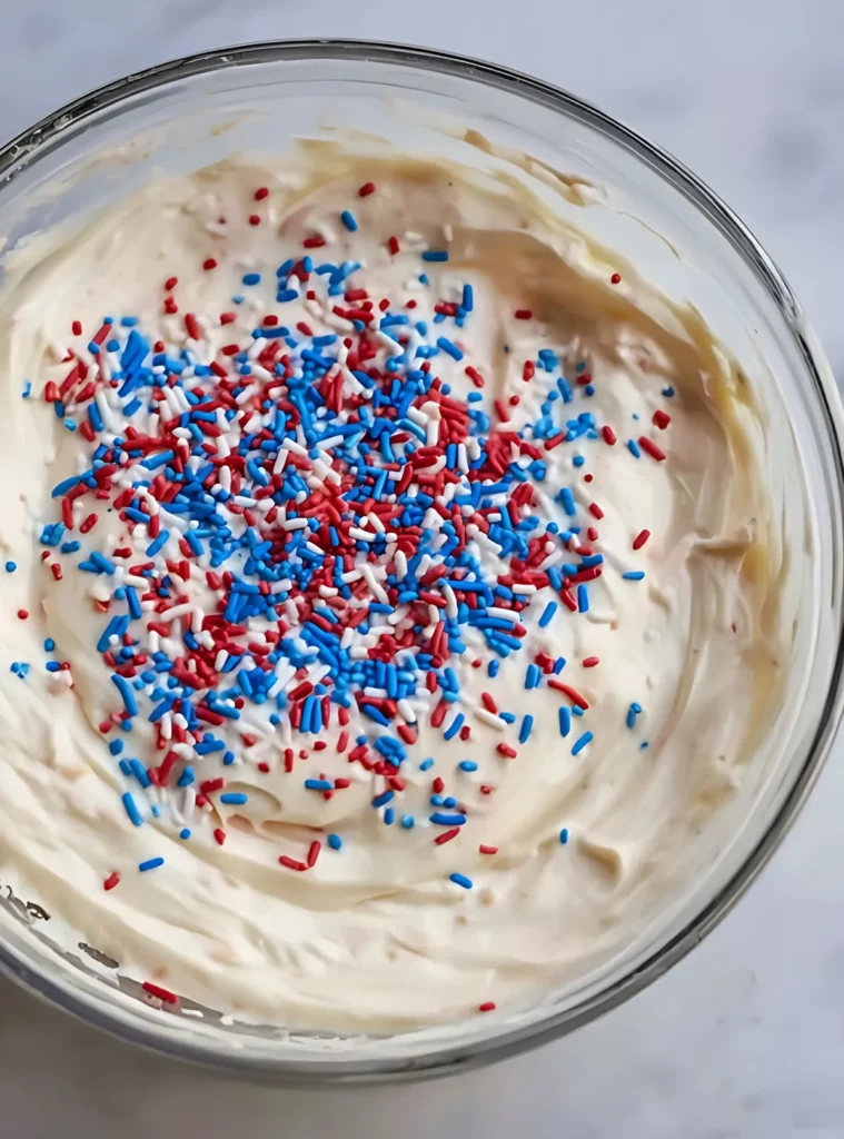 sprinkle-topped cake dip in clear bowl