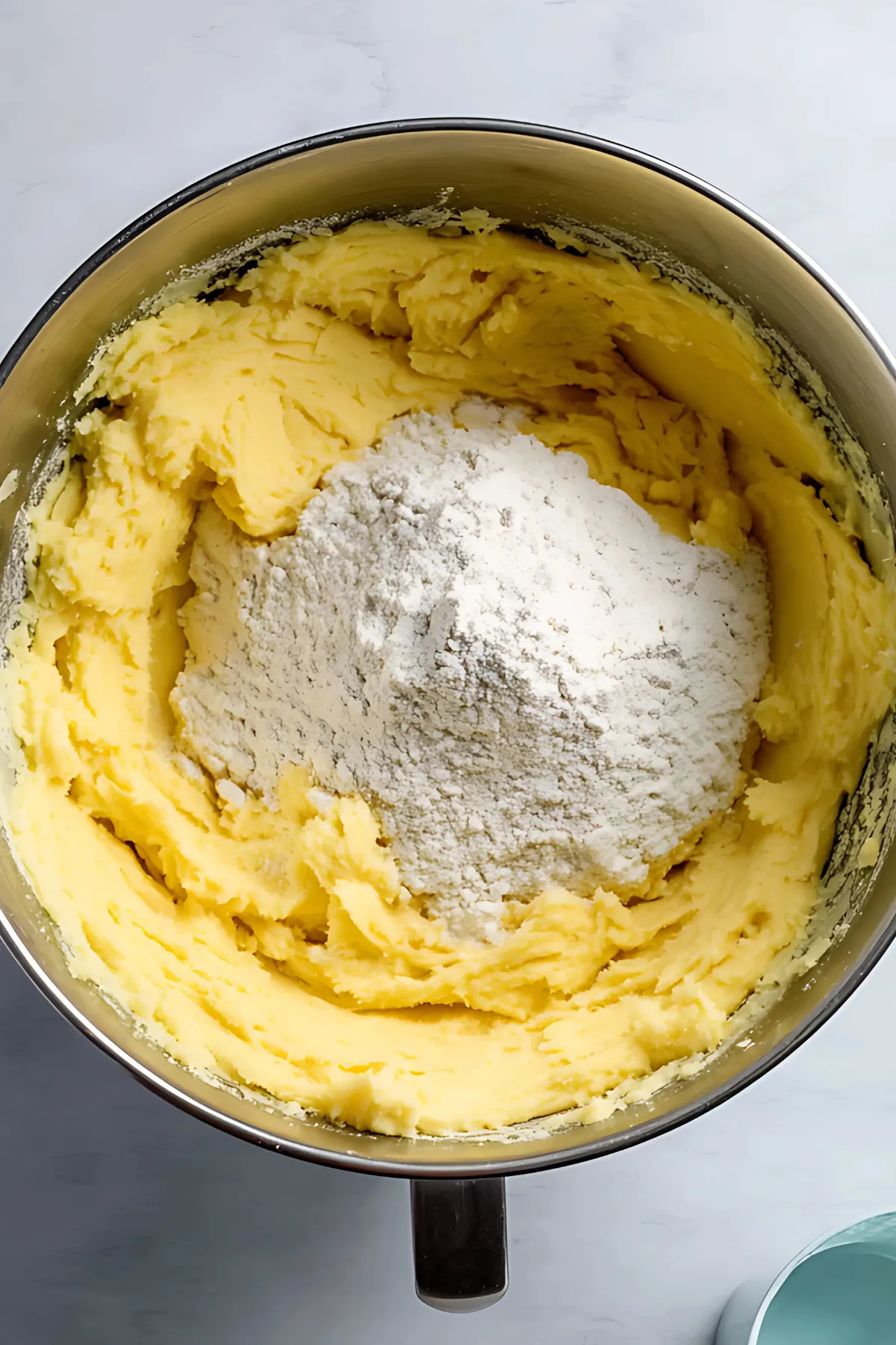 Mixing bowl with flour on yellow dough