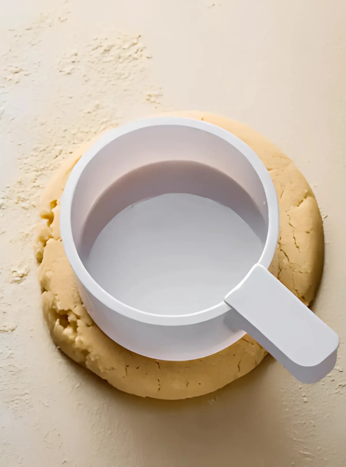 Pressing cookie dough with flat cup