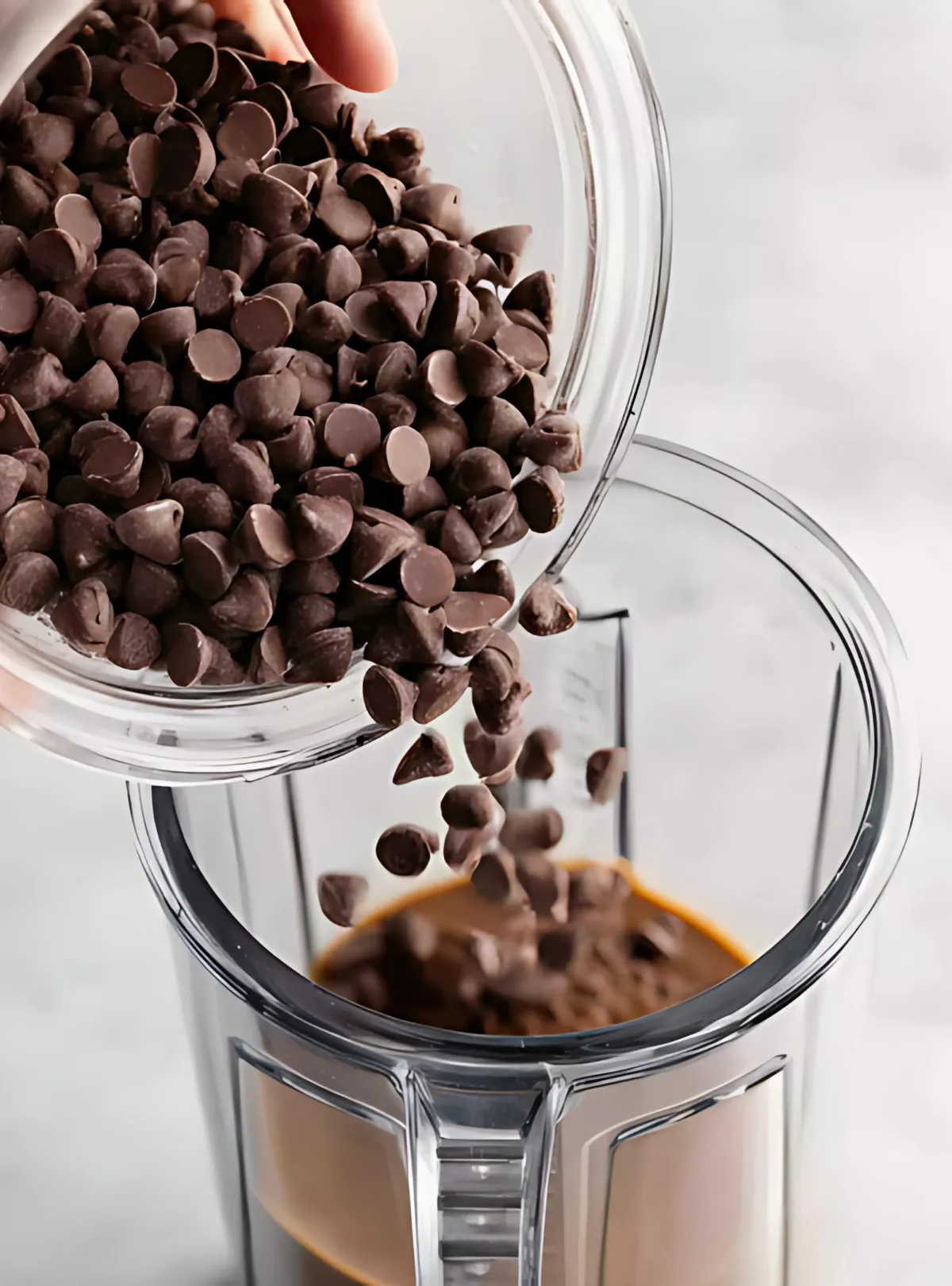 chocolate chips poured into blender with coffee