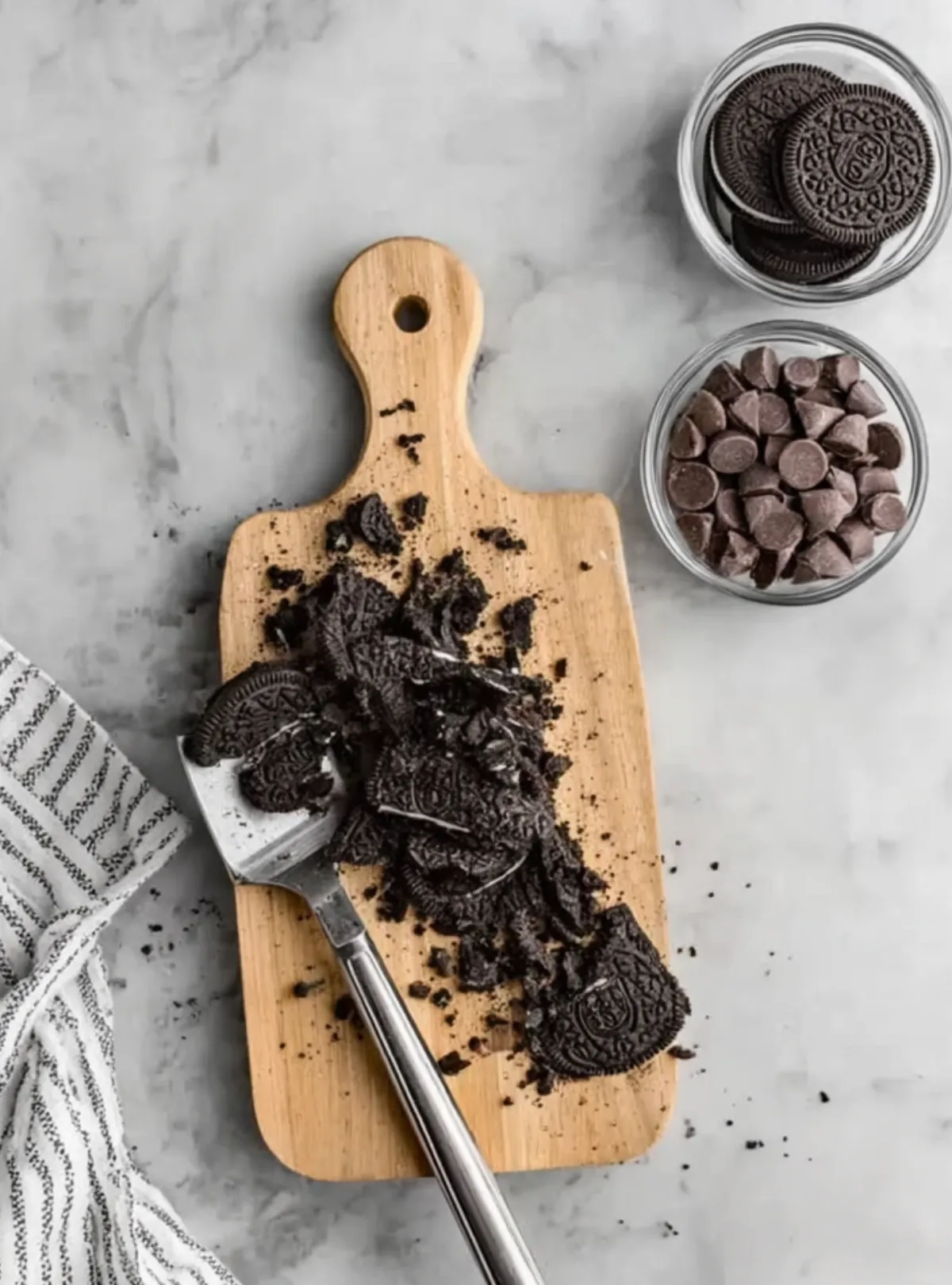 crushed Oreos on cutting board with spatula
