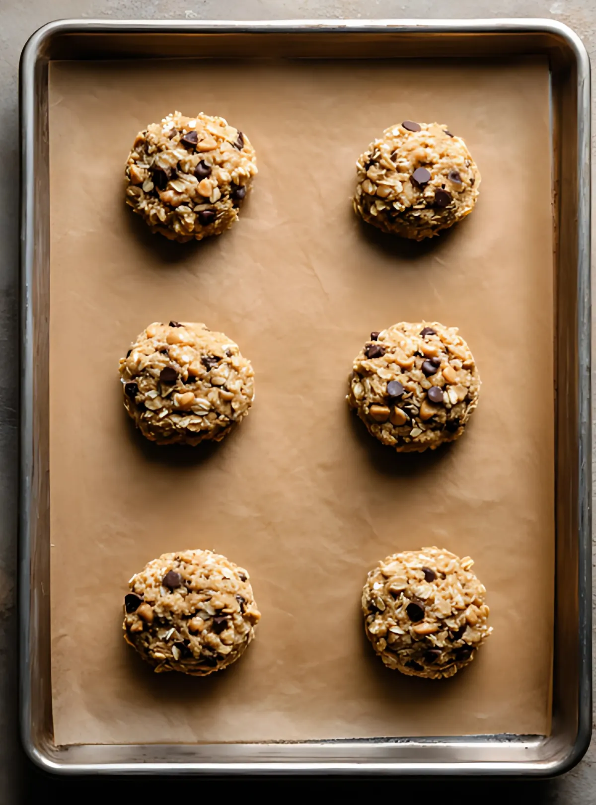portioned cookie dough on parchment tray