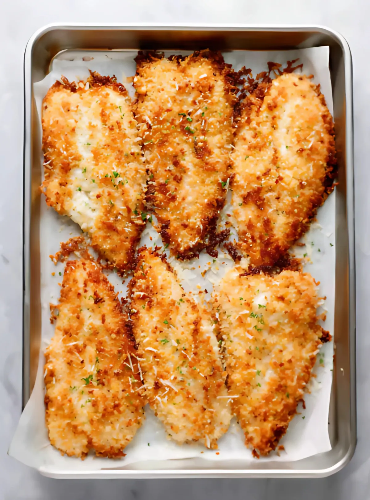 Baked tilapia fillets on tray