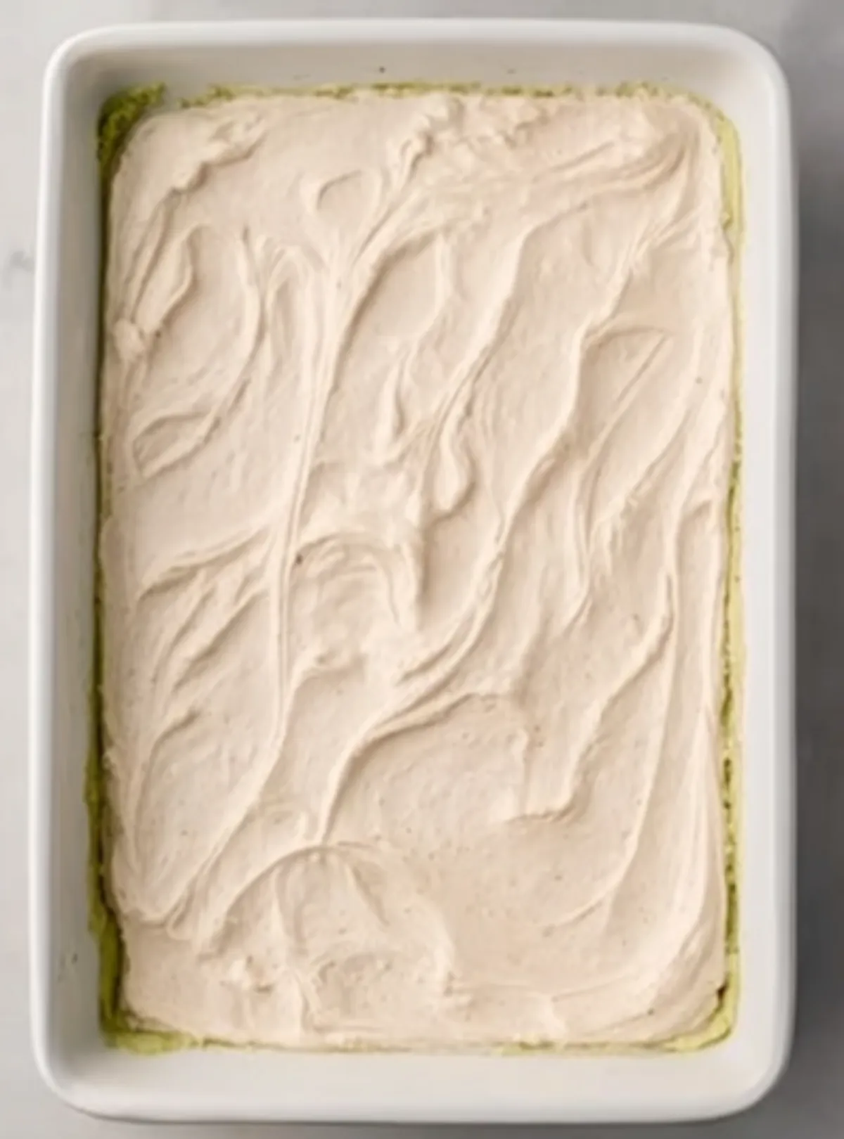 Creamy sour cream layer over guacamole