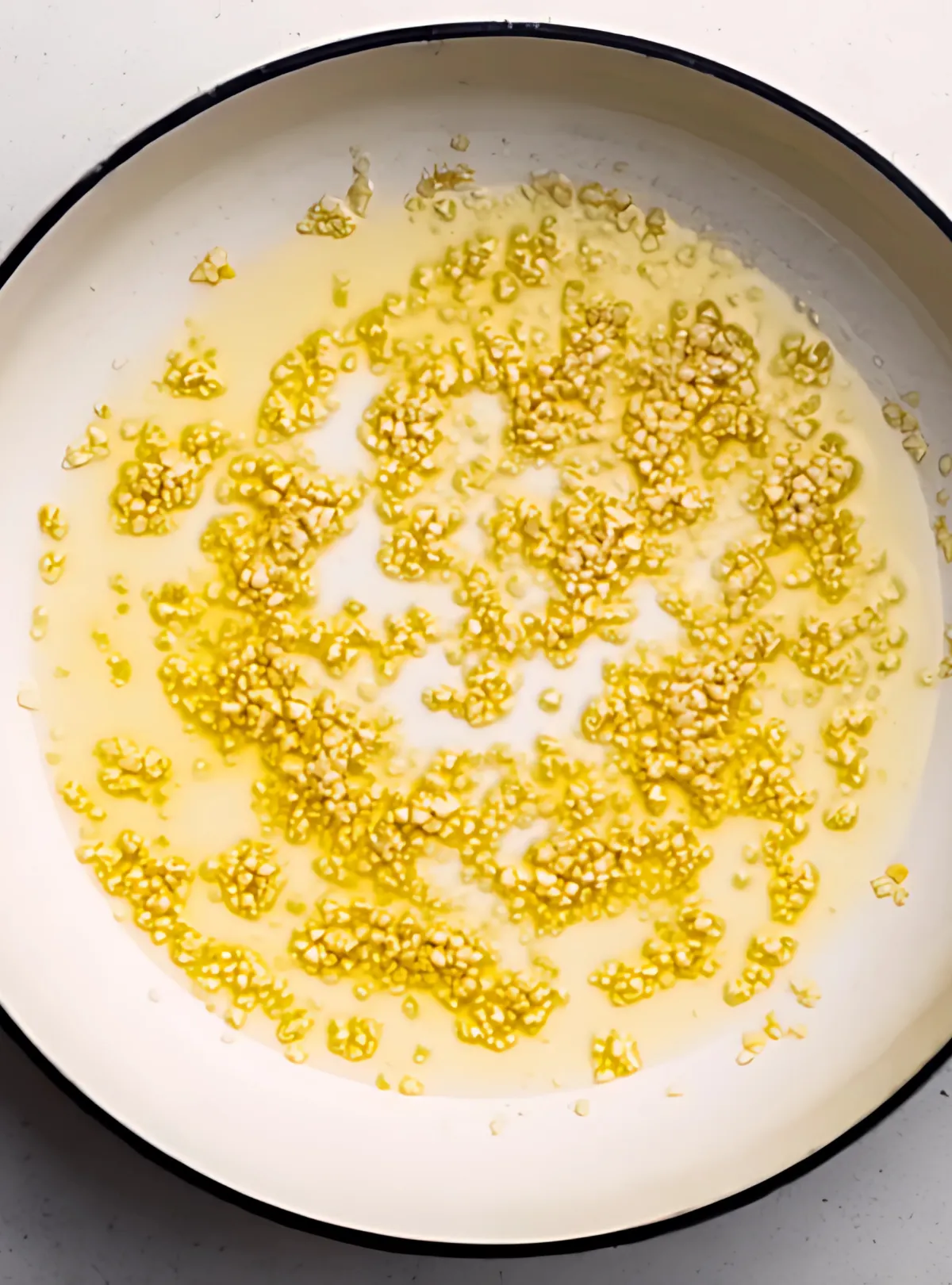Garlic sautéing in olive oil in skillet