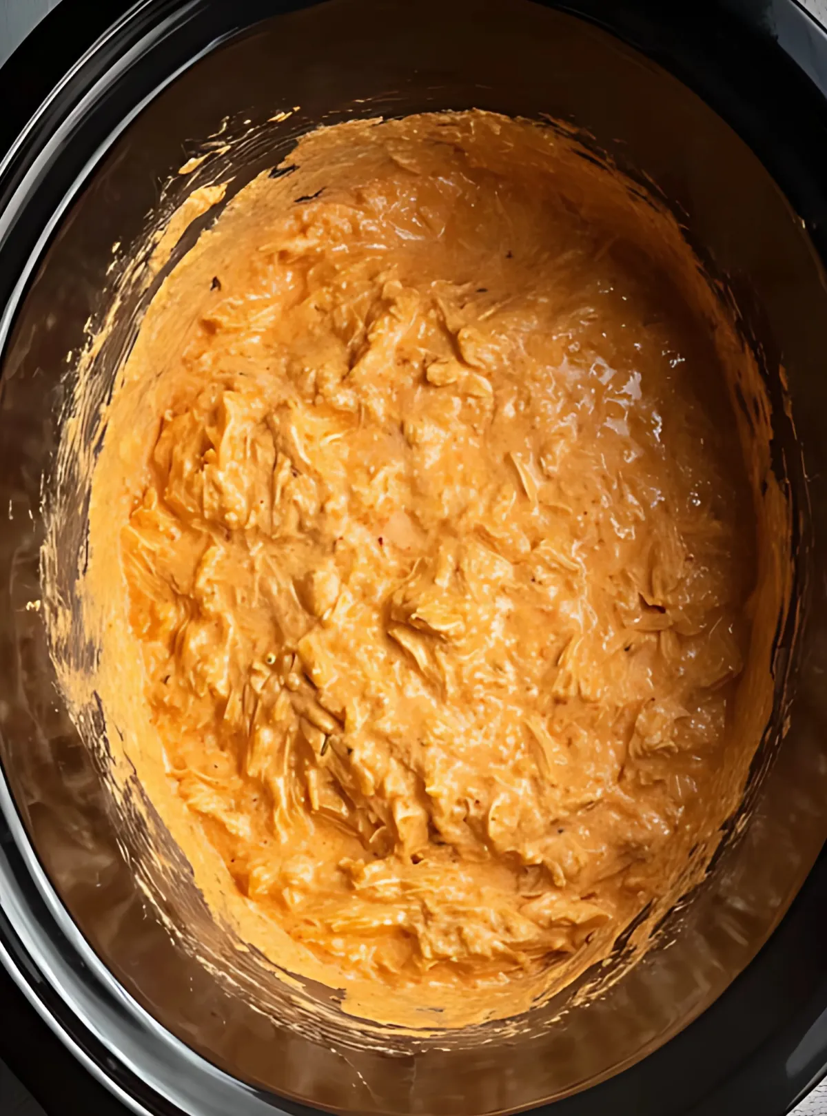 Mixed buffalo chicken dip cooked in slow cooker