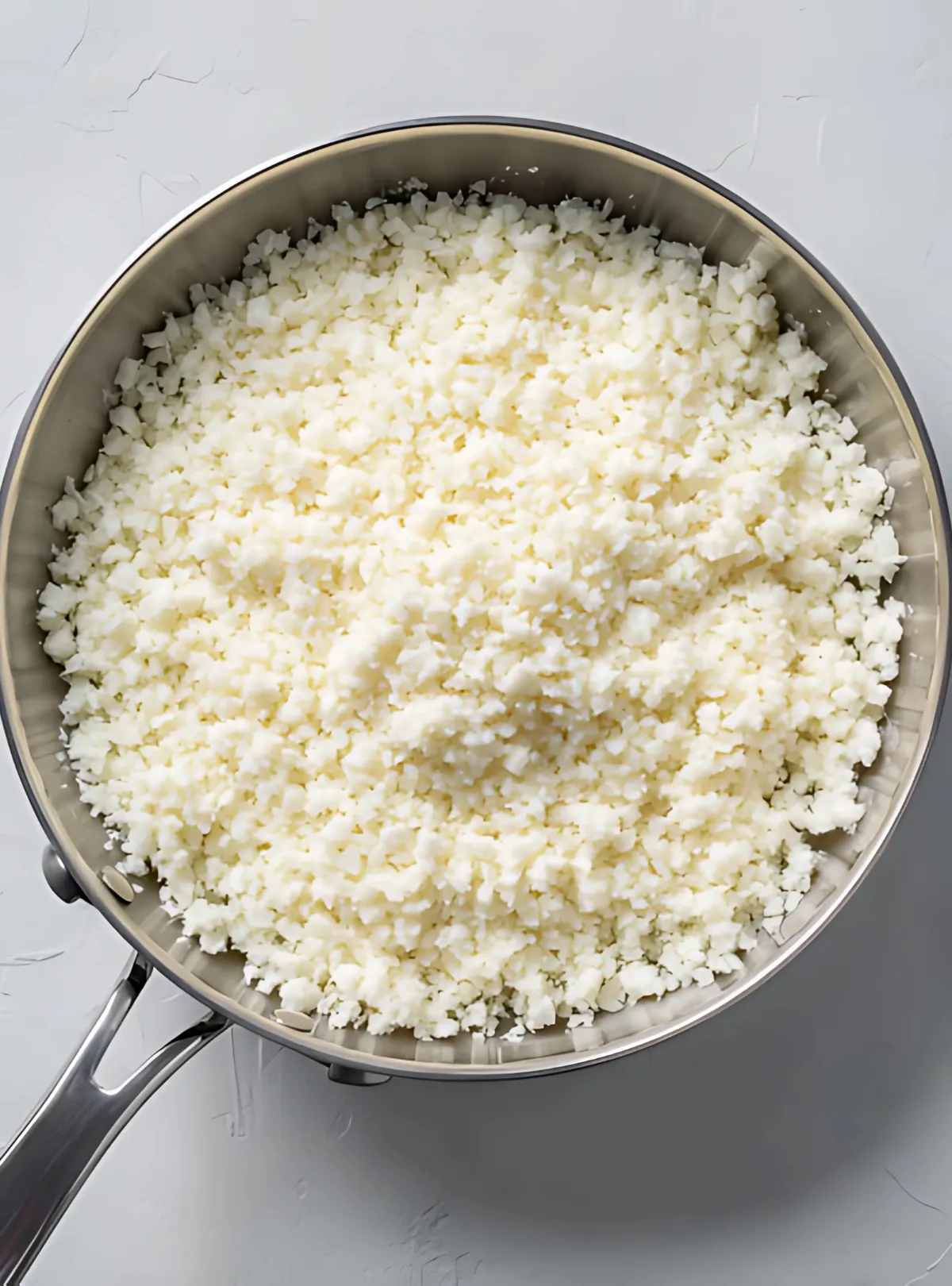 Riced cauliflower in metal pan