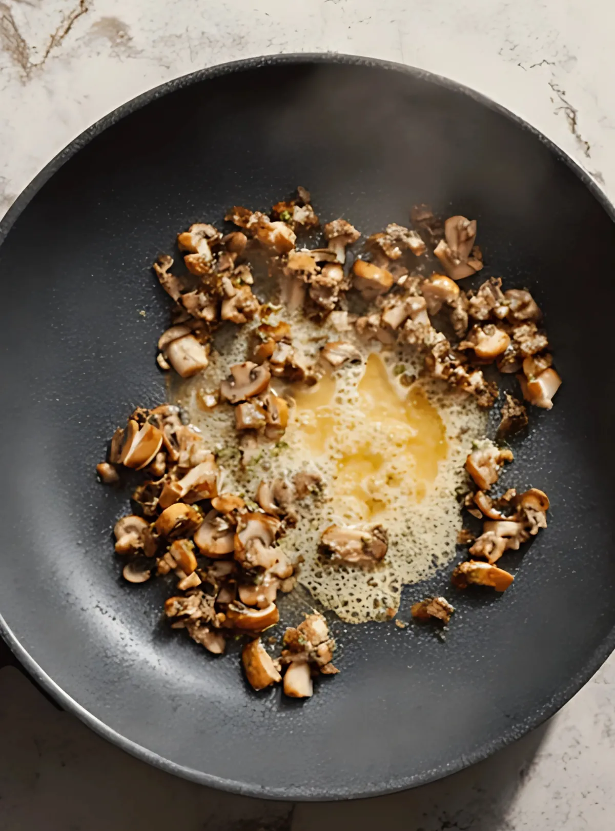 chopped mushrooms cooking in butter