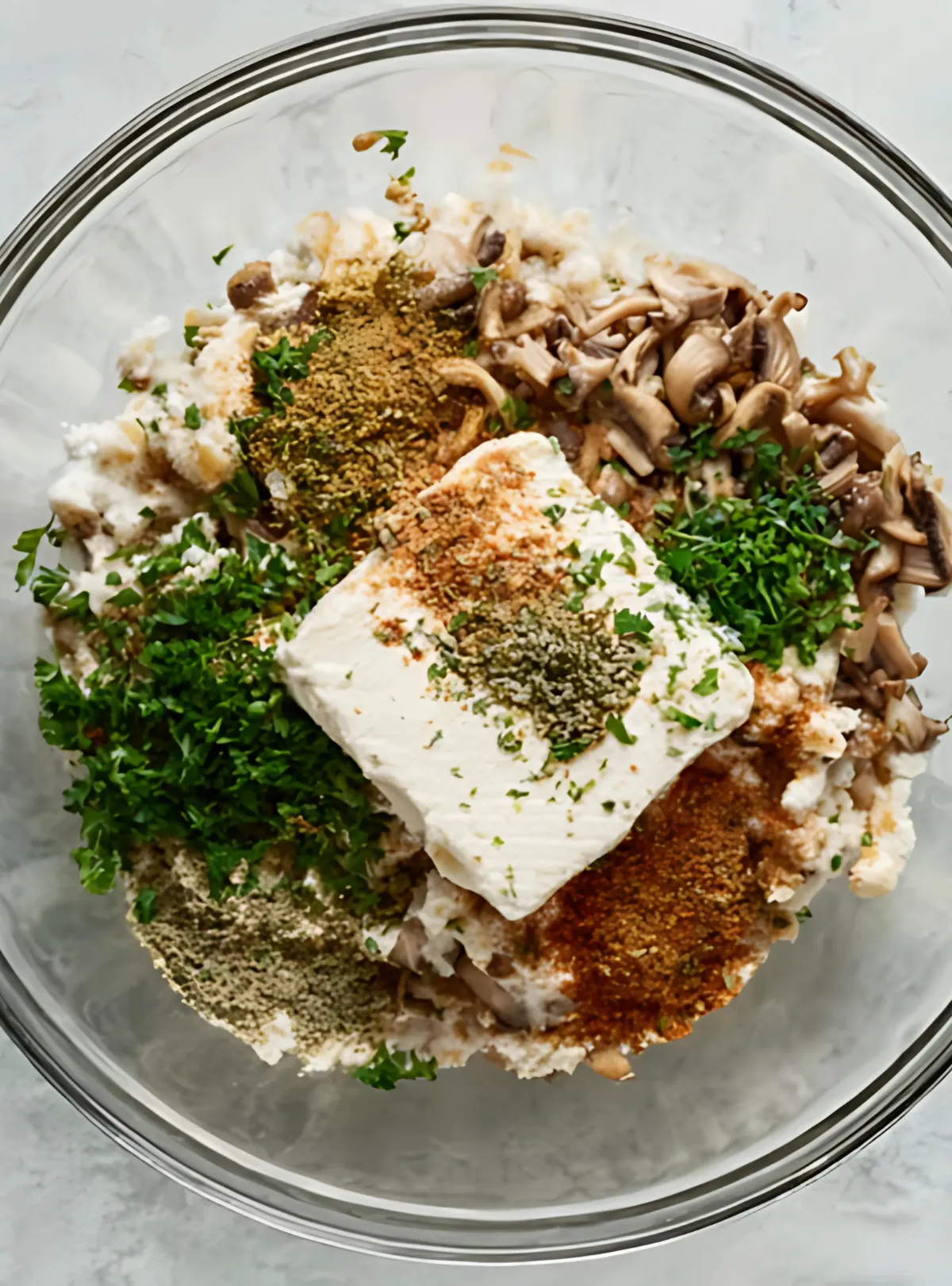 cream cheese and spices in glass bowl