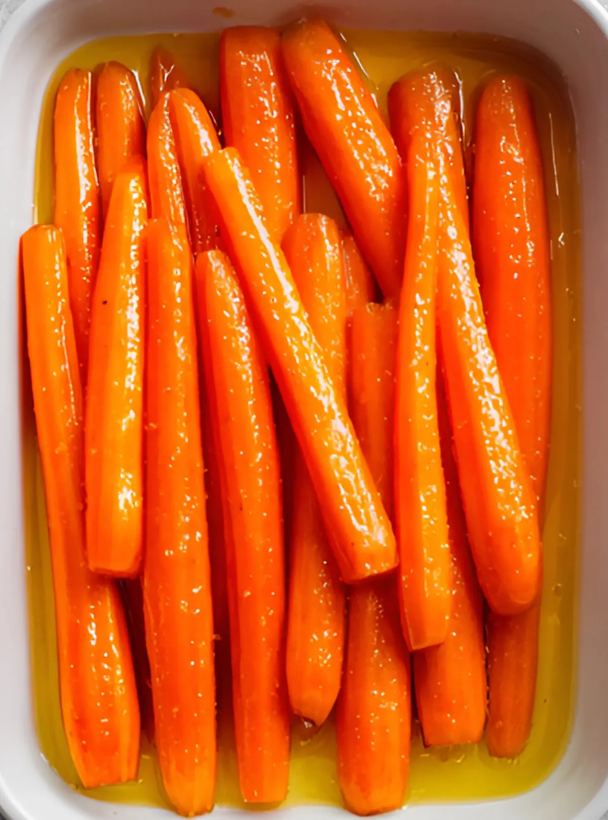 raw carrots in marinade in white dish