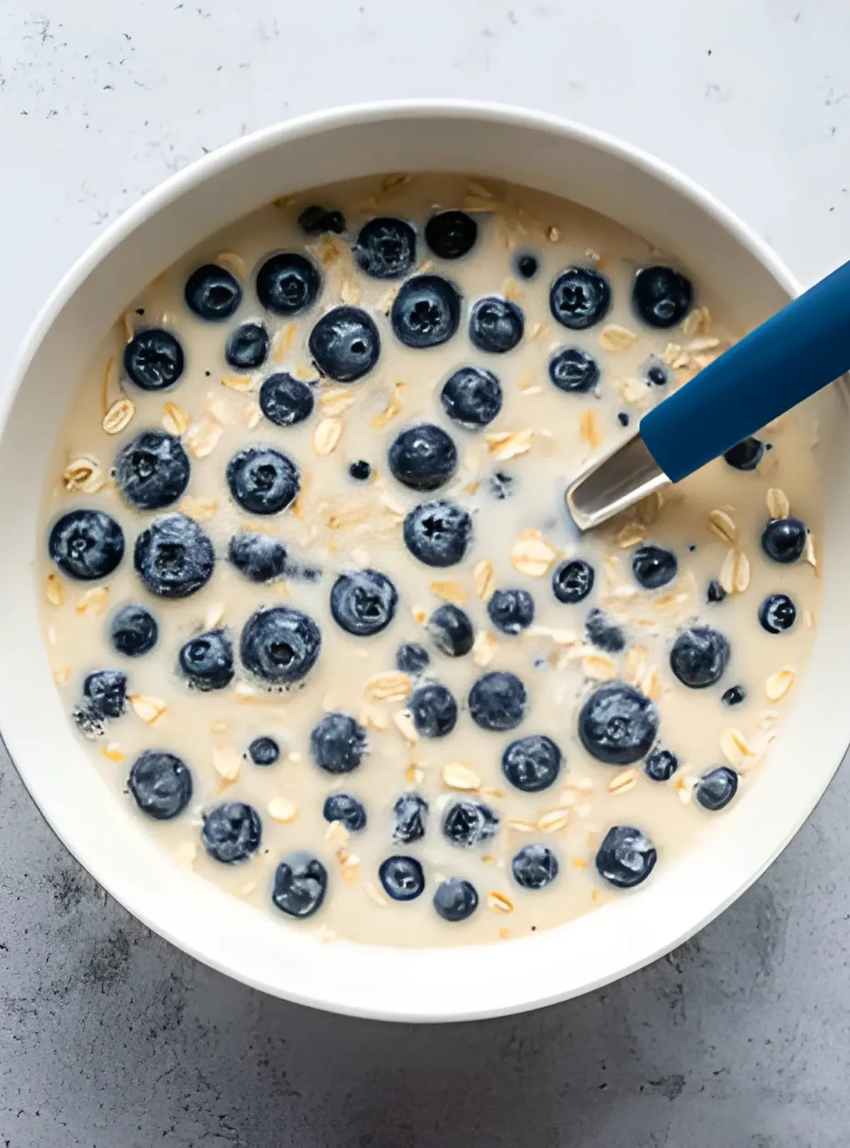 Baked oatmeal slice on plate with yogurt