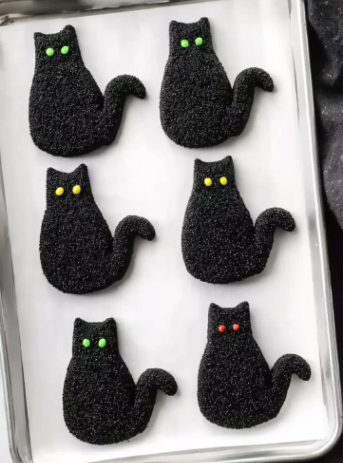 Black cat cookies with green eyes