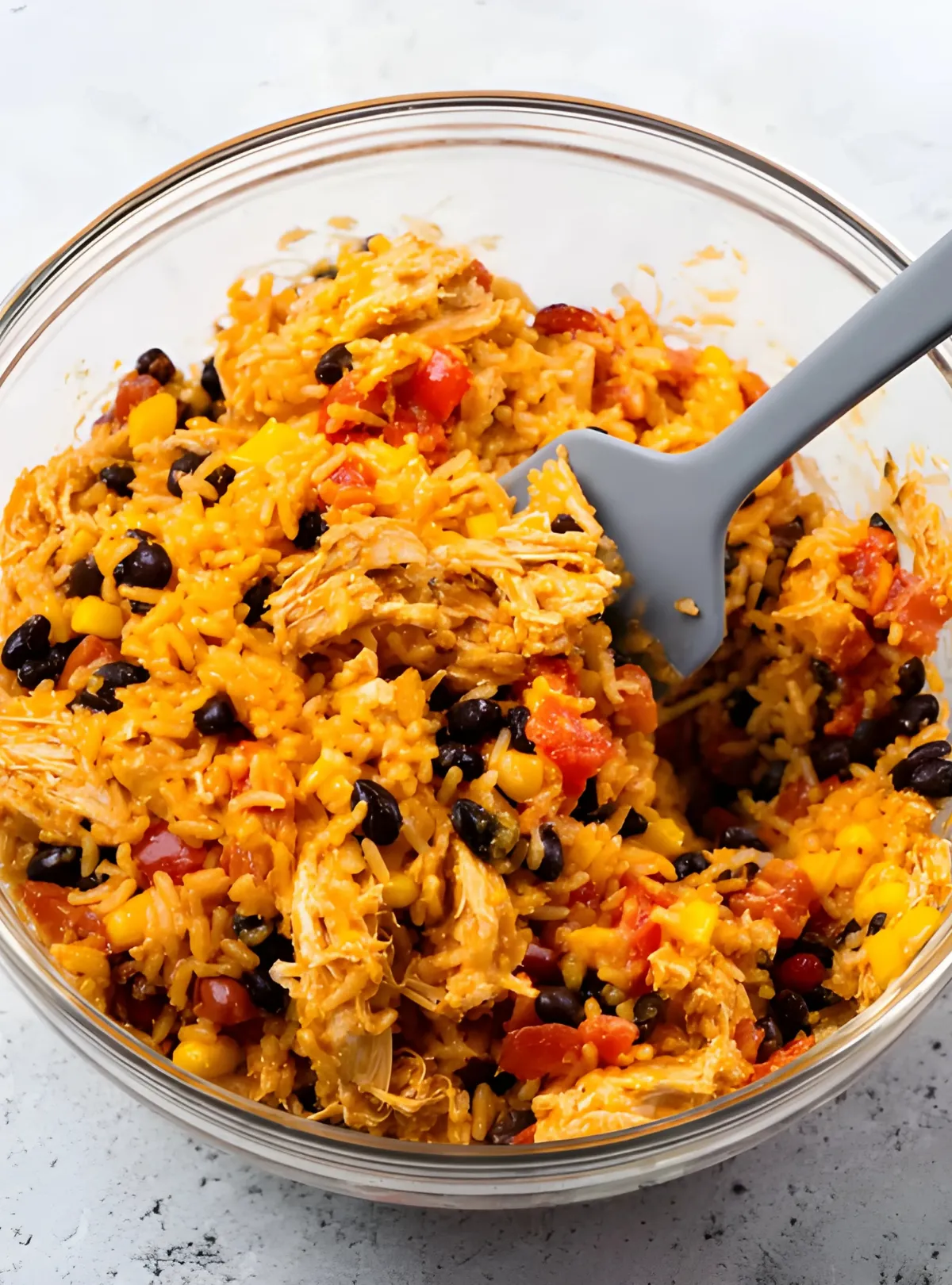 Chicken rice and beans mixture in glass bowl