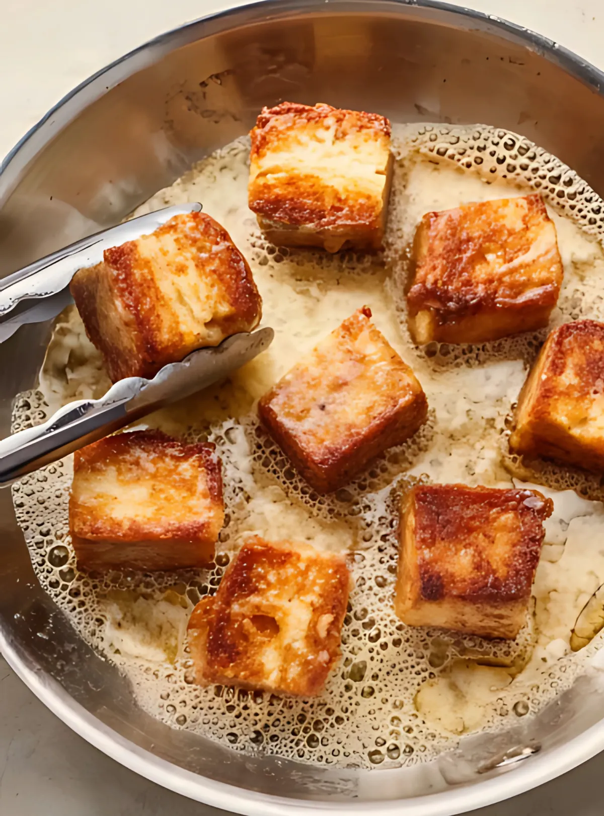 French toast cubes frying in butter