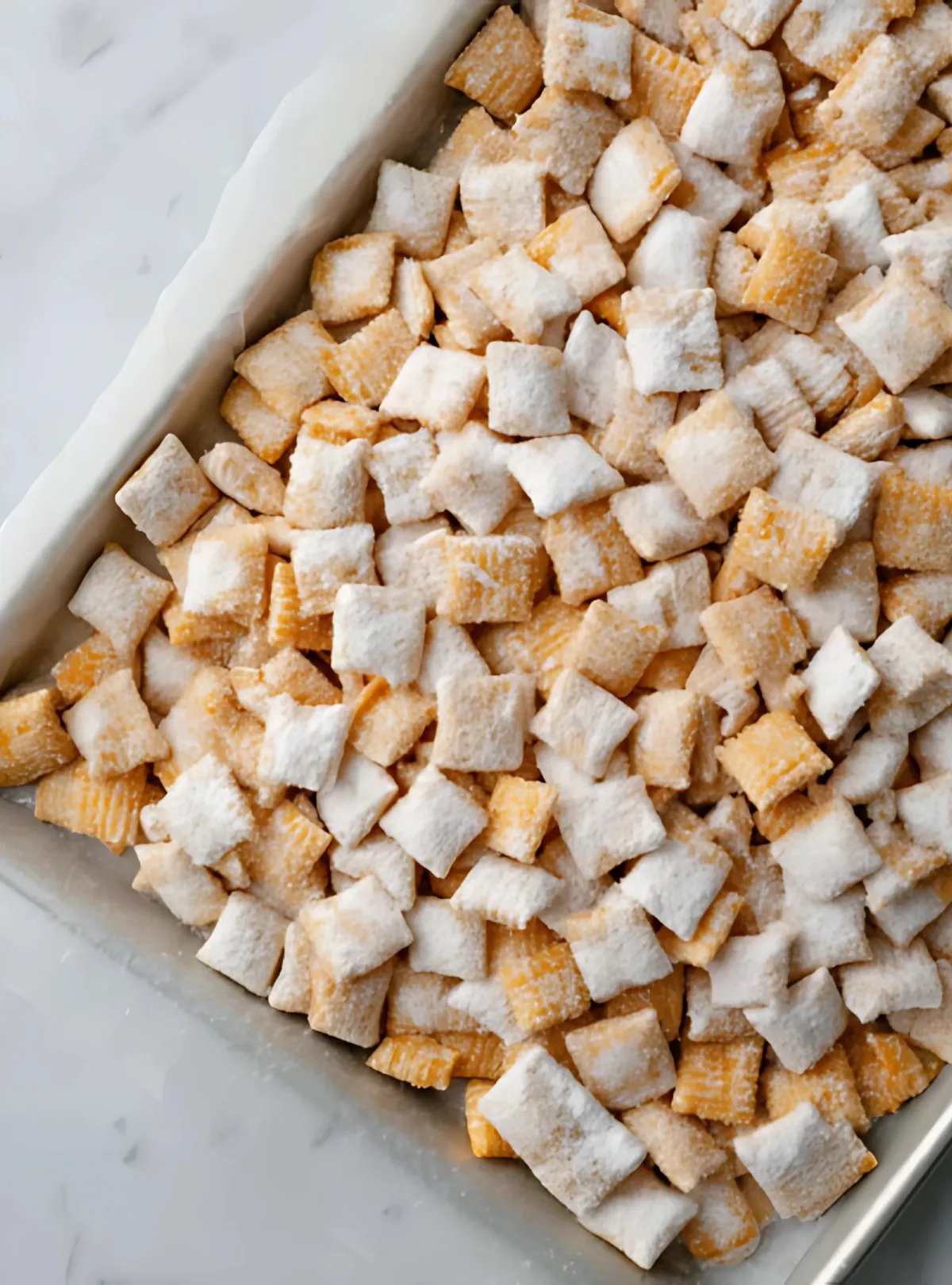 Glass bowl of puppy chow with Reese’s pieces