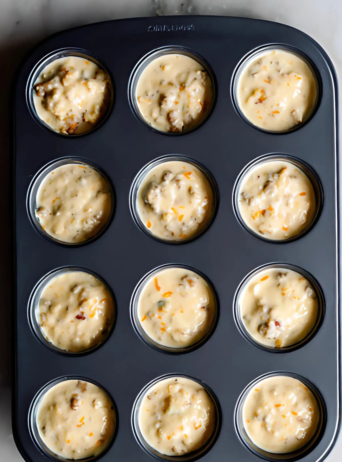 Muffin tin filled with raw batter