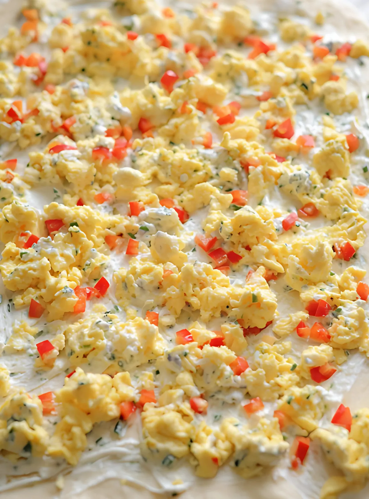 Scrambled eggs and peppers on dough