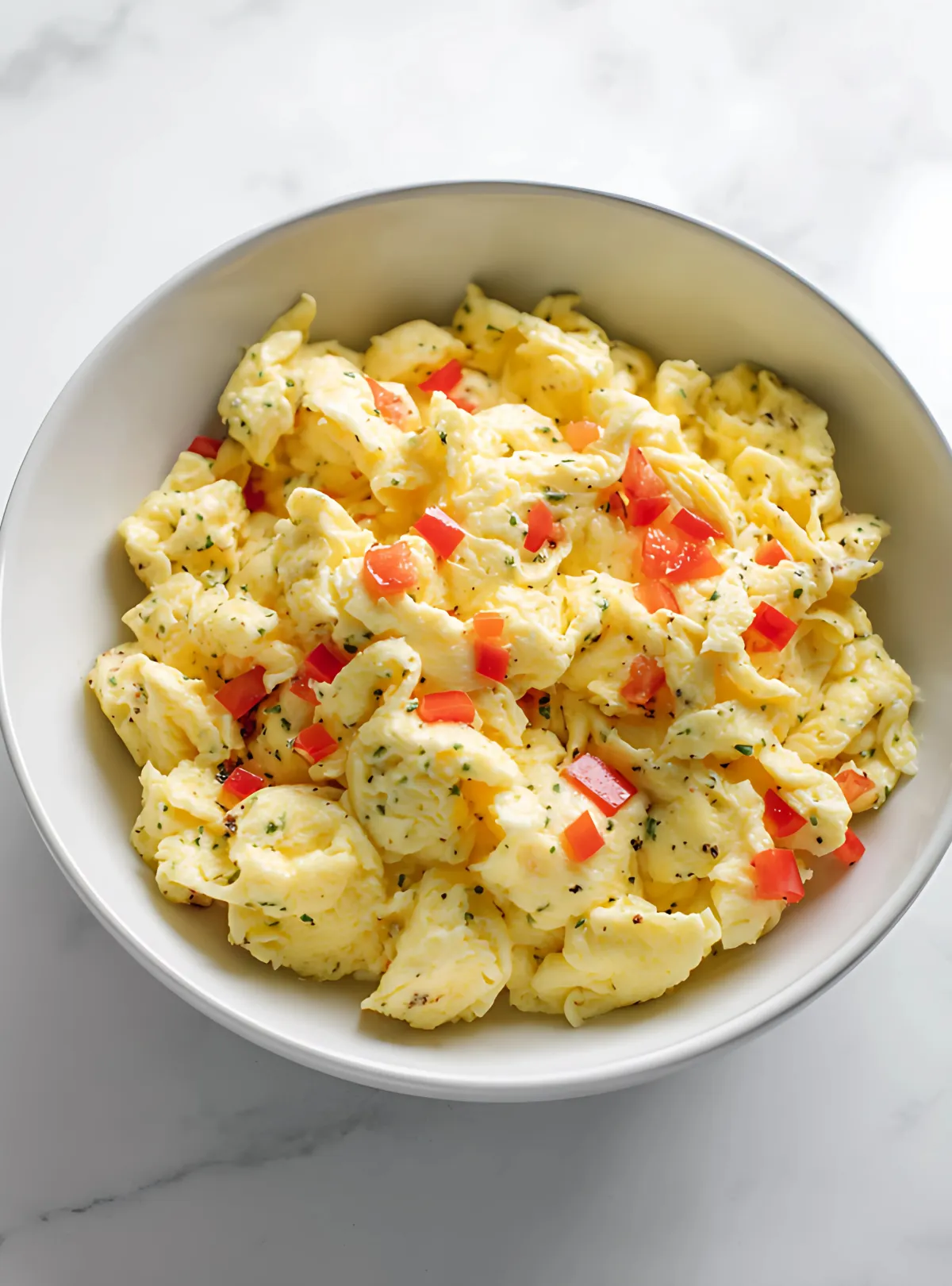 Scrambled eggs with red peppers in bowl