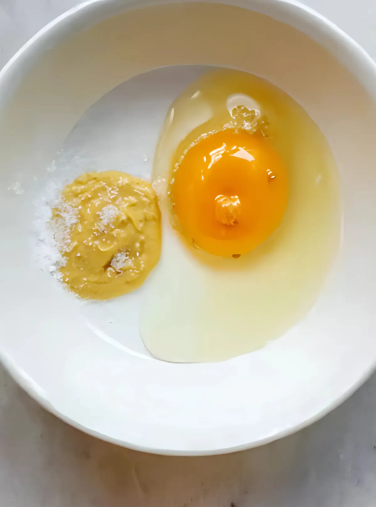 egg mustard and salt in white bowl overhead