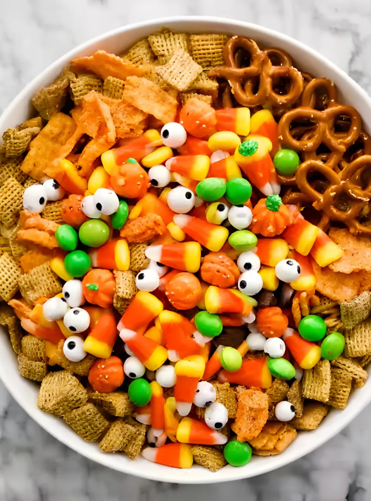 halloween snack mix with candy pumpkins and eyeballs