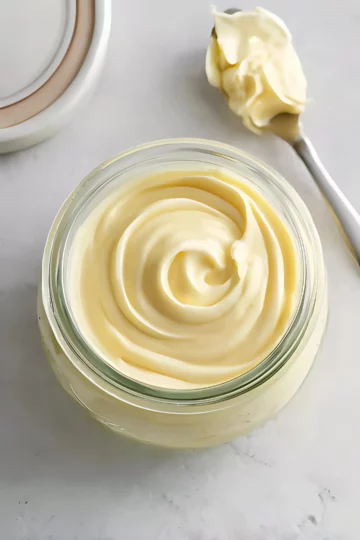 jar of mayonnaise with spoon on marble surface